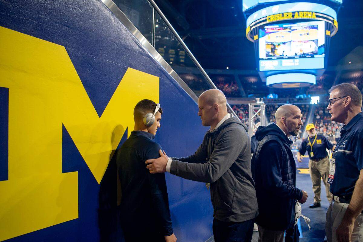 Penn State wrestling coach Cael Sanderson massages Alex Facundo as he gets ready for his first bout in the Big Ten wrestling championships at the Crisler Arena in Ann Arbor Michigan on Saturday, March 4, 2023.