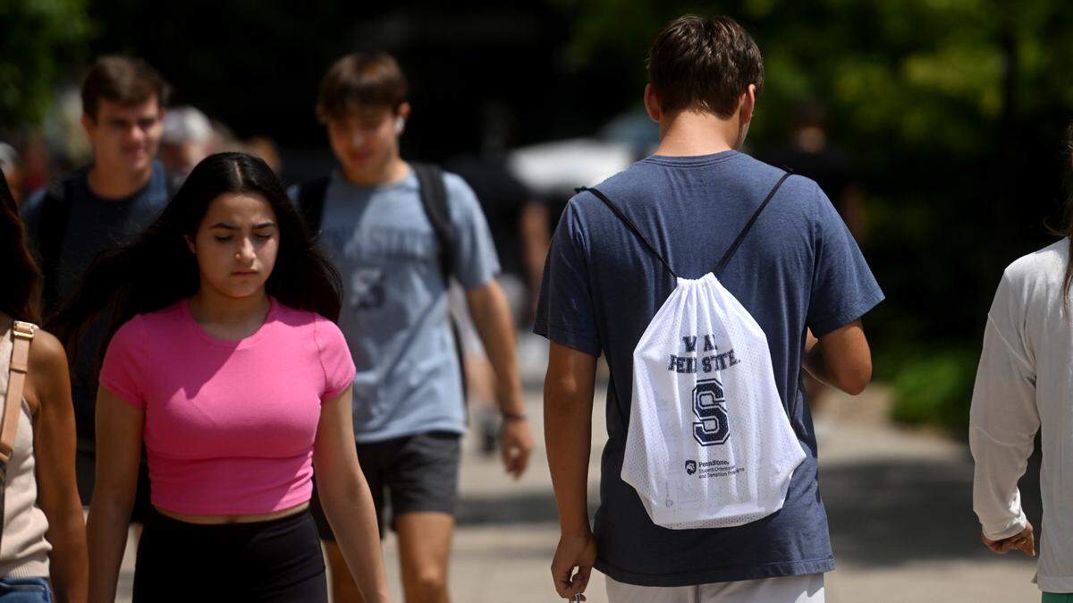 Students walk on the Penn State campus on Thursday, July 20, 2023.