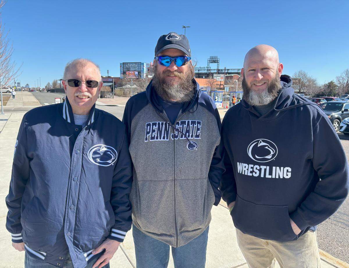 Three Penn State fans, from Indiana and Texas, pose Friday outside of the Wells Fargo Arena that’s hosting the 2025 NCAA Wrestling Championships in Philadelphia. From left to right, they are Dan Hall (Indiana), Keith Parsons (Indiana) and Greg Parsons (Texas).