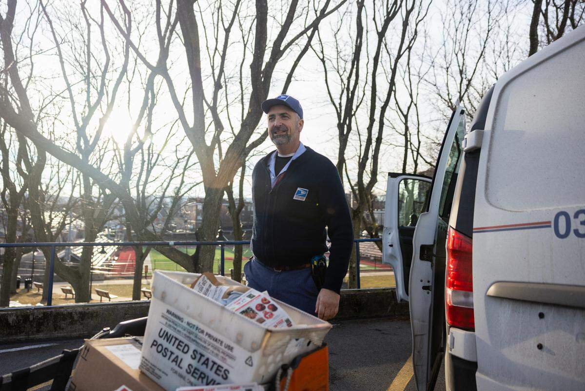 USPS mail carrier Michael Frank prepares his mail truck before starting his route on Tuesday, Jan. 13, 2026 in State College. Frank has been recognized for traveling around a million miles while working as a USPS mail carrier over the course of 31 years.