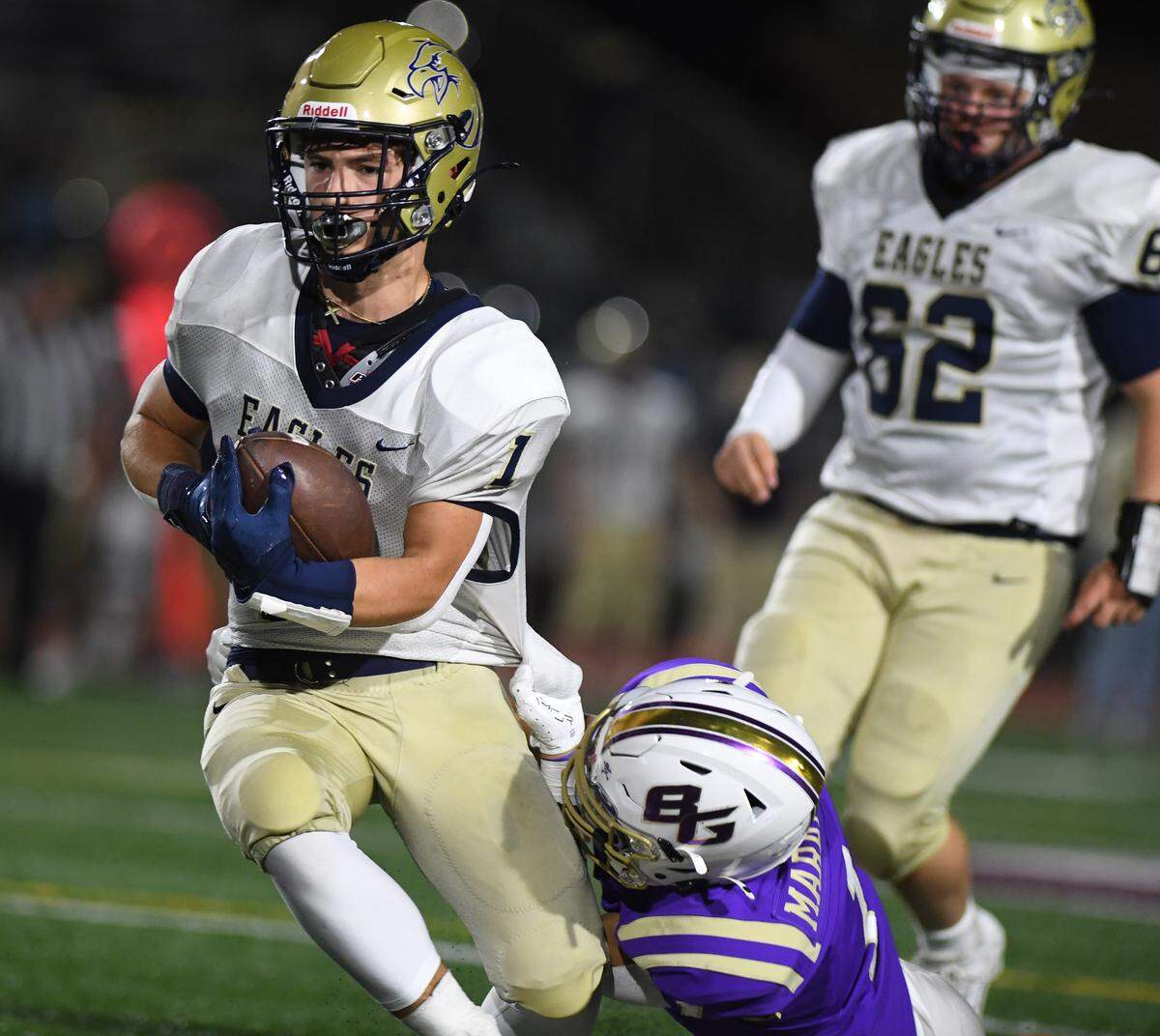 Bald Eagle Area’s Kollin Cunningham (1) is dragged down from behind by Bishop Guilfoyle’s Tyson Lestochi in the third quarter Saturday at Altoona’s Mansion Park.