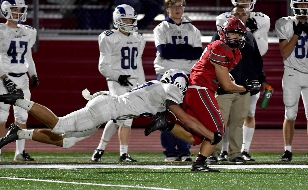 Penns Valley’s Austin Fisher tries to pull down Bellefonte’s Chris Paloskey after he made an interception during the game on Friday, Oct. 4, 2019.