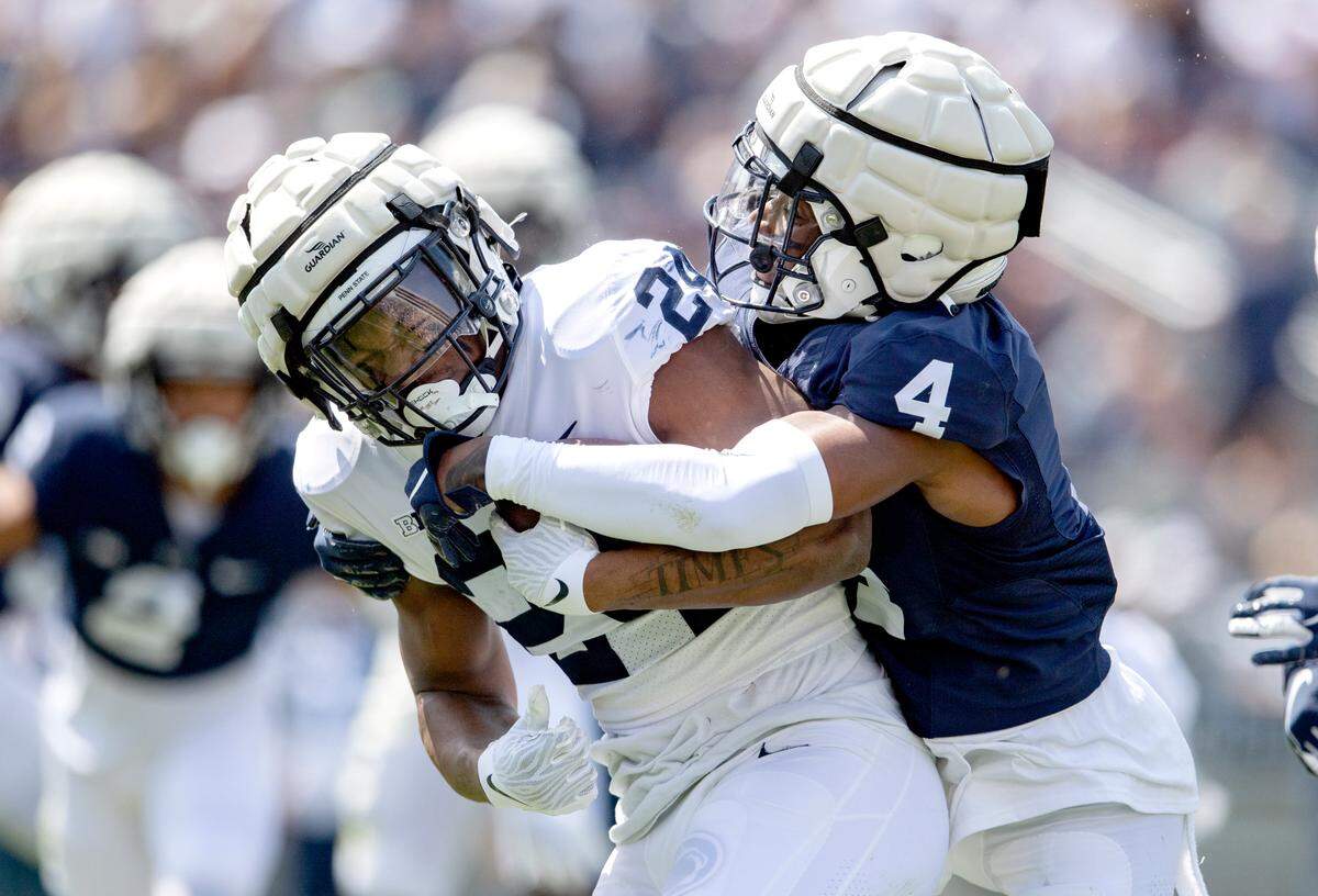 Penn State cornerback Kalen King stops Penn State running back Keyvone Lee during the Blue-White game on Saturday, April 23, 2022.