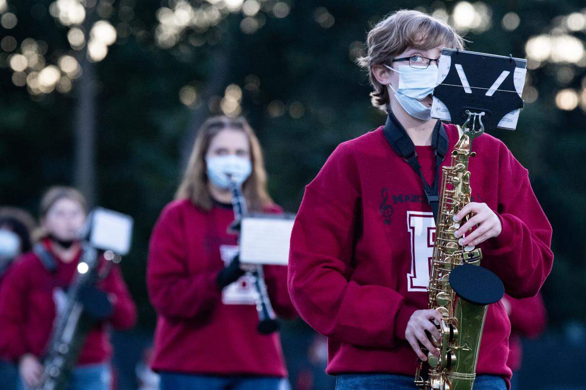 A member of the Bellefonte Area High School Band plays the saxophone through his mask before Bellefonte Area High School’s game against Penns Valley Area High School on Friday, Oct. 2, 2020 in Bellefonte, Pa.