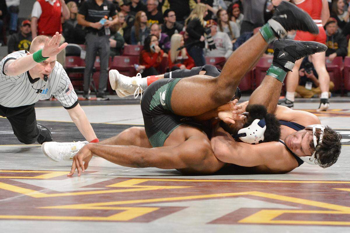 Penn State’s Shakur Rasheed cradles up Michigan State’s Cameron Caffey in their 184-pound quarterfinals match during the Big Ten Championships. Rasheed pinned Caffey in 5:17.