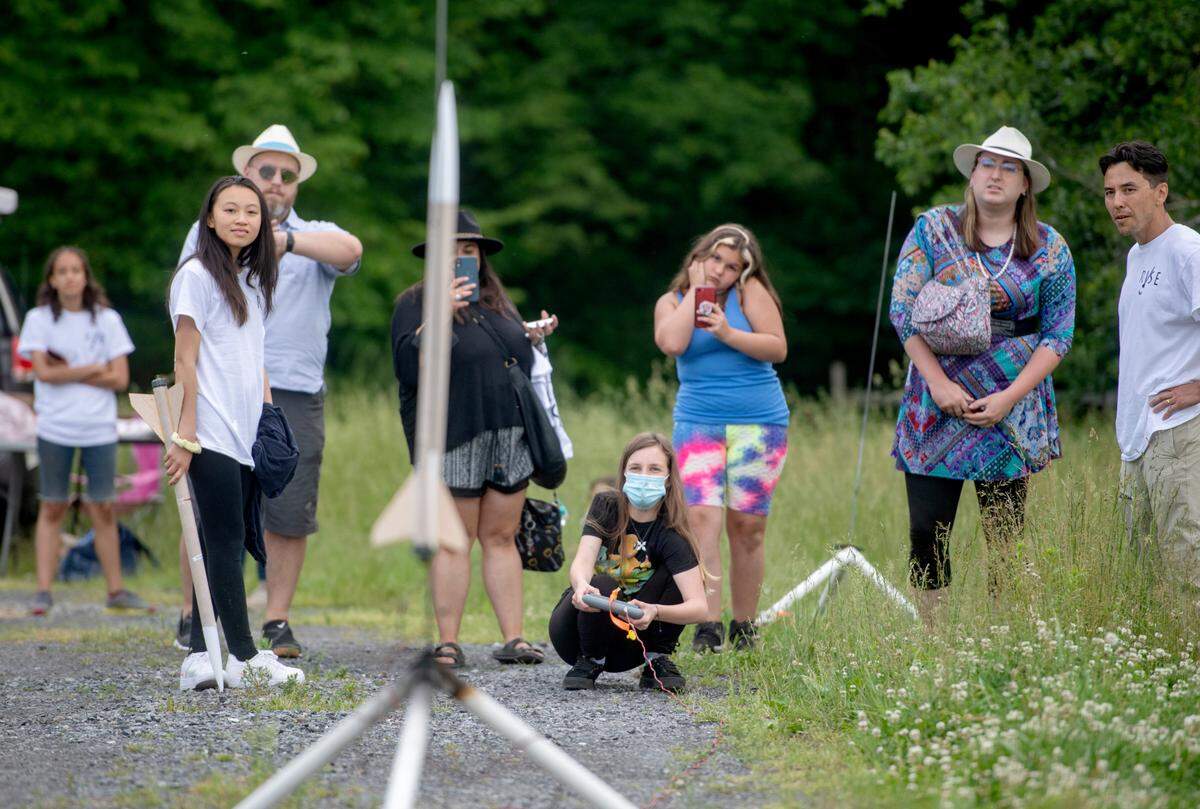 Classmates, family and friends gather around London Judy as she launches her rocket on Thursday, June 2, 2022. Twenty State College students participated in Rockets for Inclusive Science Education through the school year, which culminated in a launch.