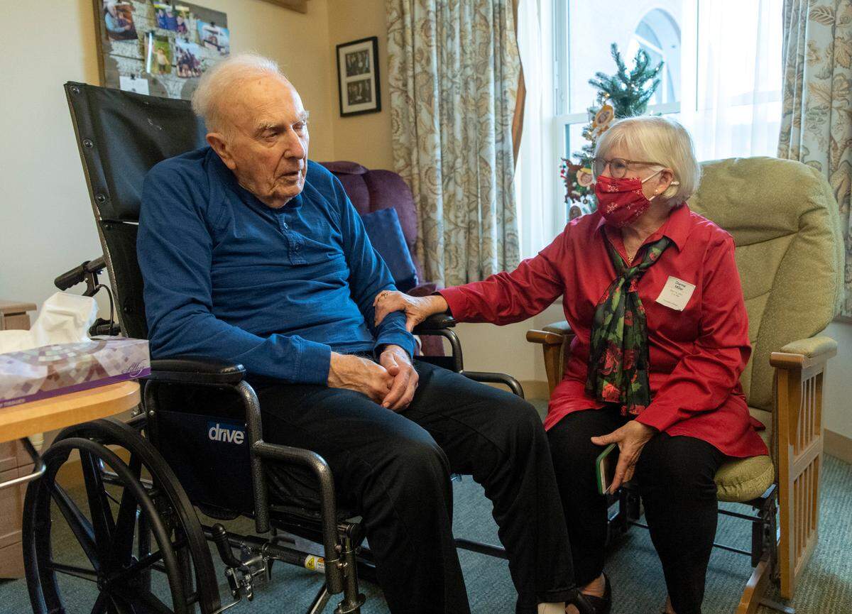 Win Miller chats with his wife, Dianne, in his room at Foxdale Village on Thursday, Dec. 16, 2021.