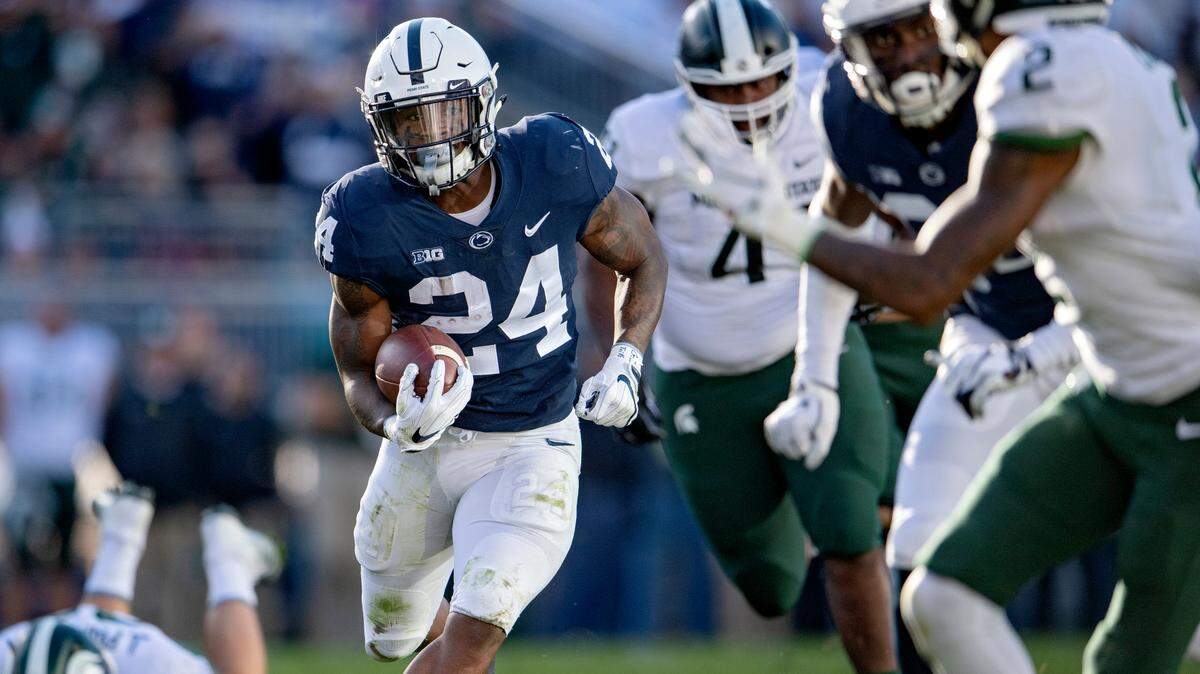 Penn State running back Miles Sanders darts down the field dodging Michigan State defenders for a touchdown during the game on Saturday, Oct. 13, 2018.  