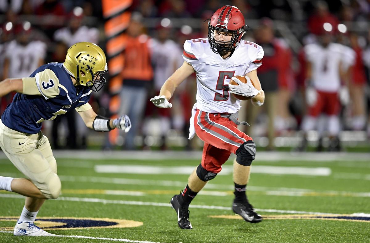 Bellefonte’s Trae Bauman darts down the field with the ball from Bald Eagle Area’s Zeb Fry during the game on Friday, Oct. 25, 2019.