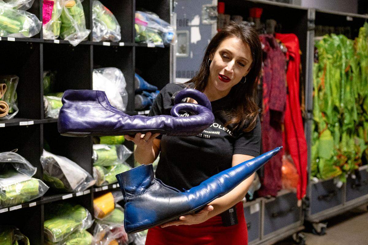 Janie Mallet shows some of the shoes worn by the clowns in Cirque du Soleil’s show “Ovo” during its stop at the Bryce Jordan Center on Thursday, March 27, 2025.