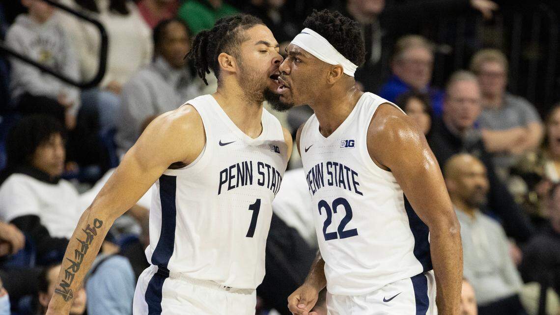 Penn State’s Seth Lundy (1) celebrates with teammate Jalen Pickett during the Jan. 8 game against Purdue at The Palestra in Philadelphia. Both players were chosen in Thursday’s NBA Draft.