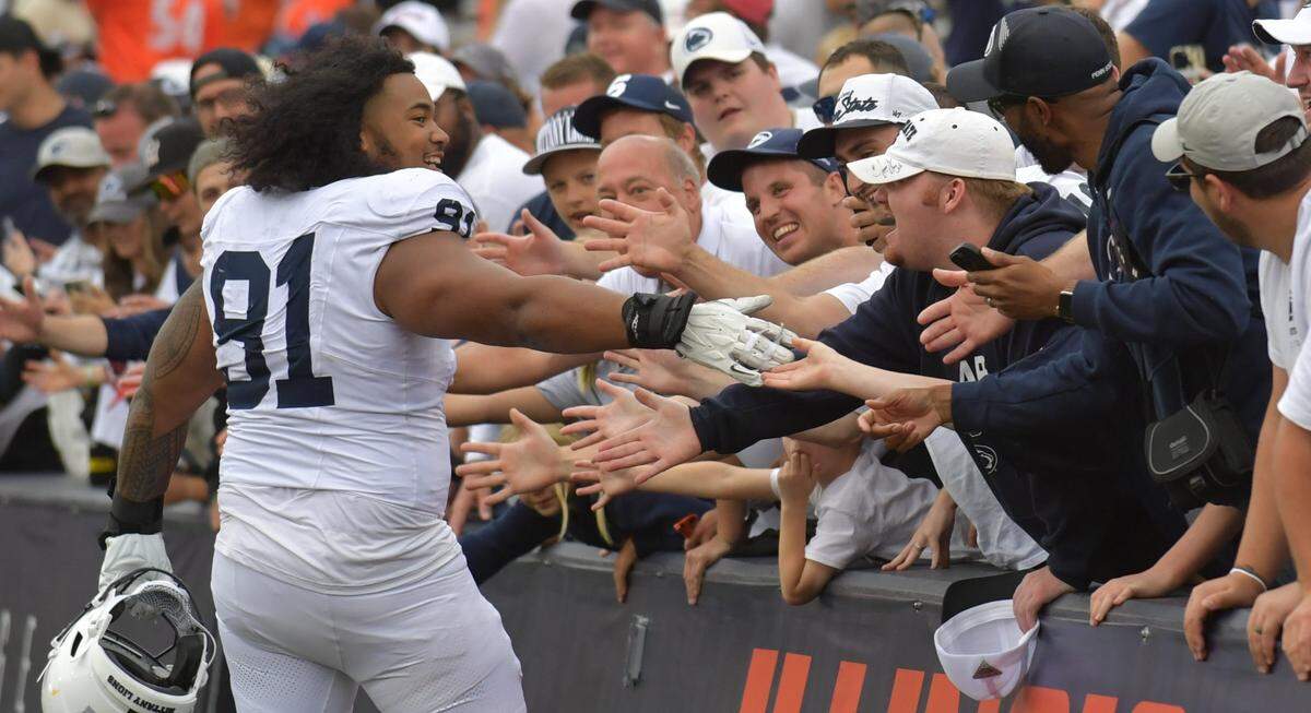 Sep 16, 2023; Champaign, Illinois, USA;  Penn State Nittany Lions defensive tackle Don Ellies gets a hand from fans after defeating the Illinois Fighting Illini at Memorial Stadium. Mandatory Credit: Ron Johnson-USA TODAY Sports
