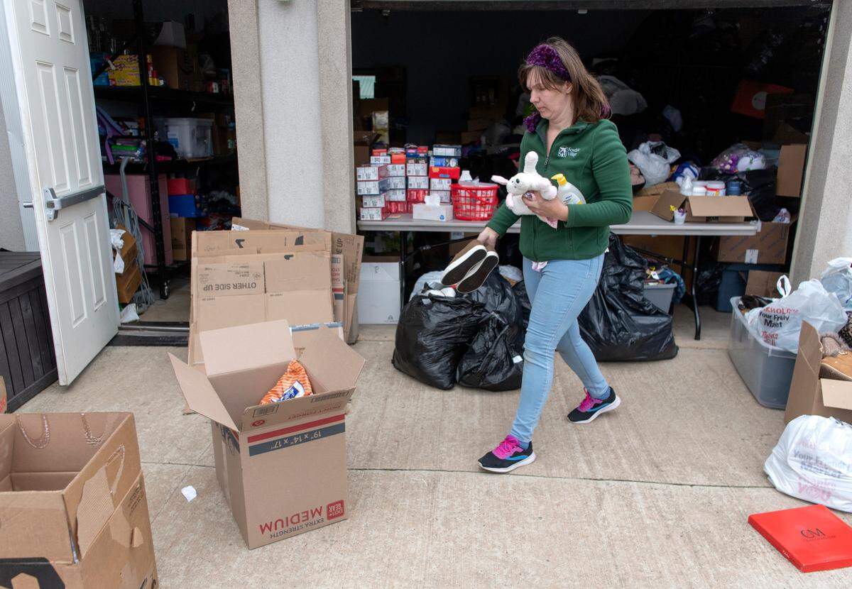 Anna Jaltir picks donated items to pack in a box that will be sent to families in Ukraine from the Salvation Baptist Church in State College Friday.