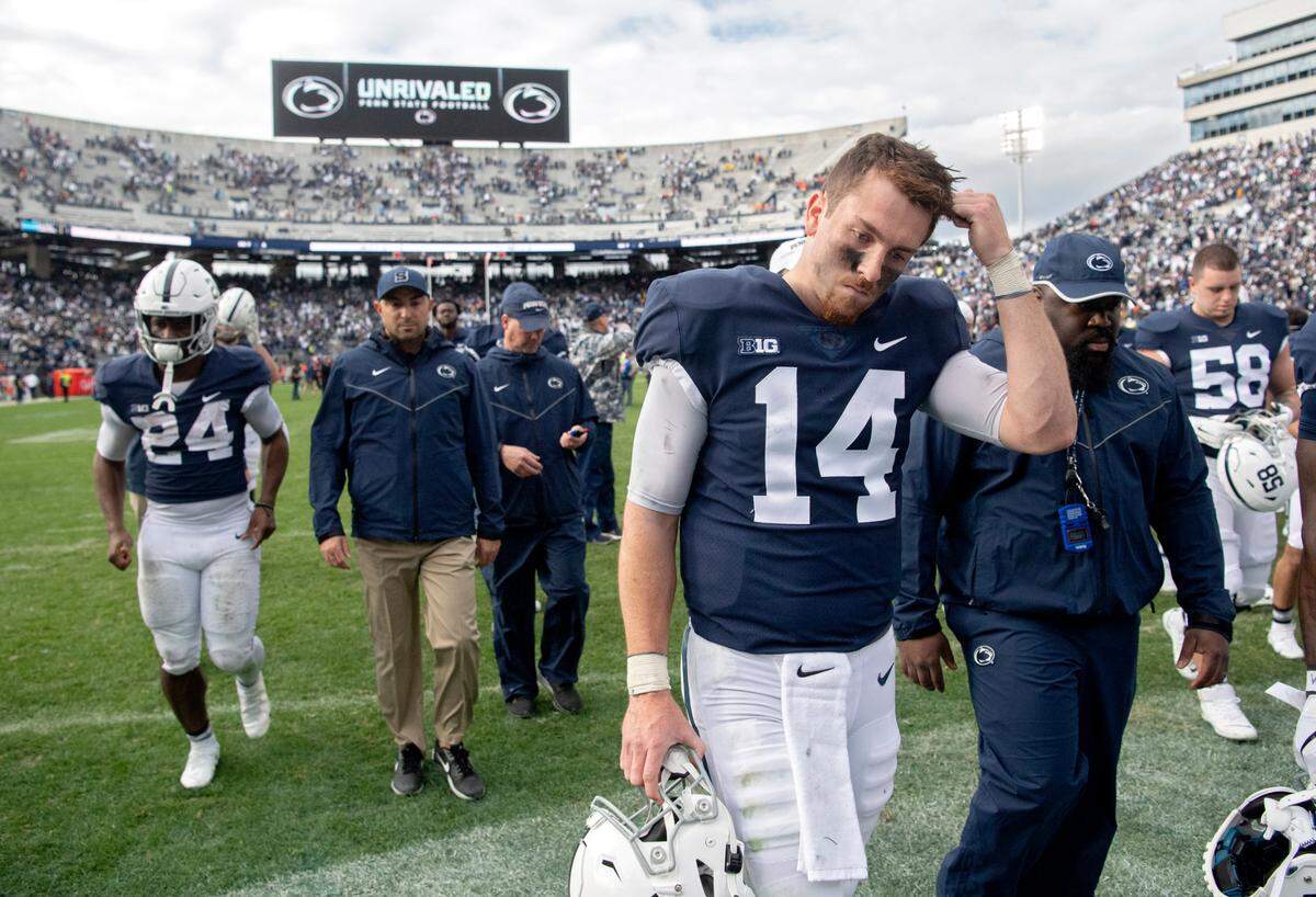 Penn State quarterback Sean Clifford walks off the field in disappointment after the 9 overtime loss against Illinois on Saturday, Oct. 23, 2021.