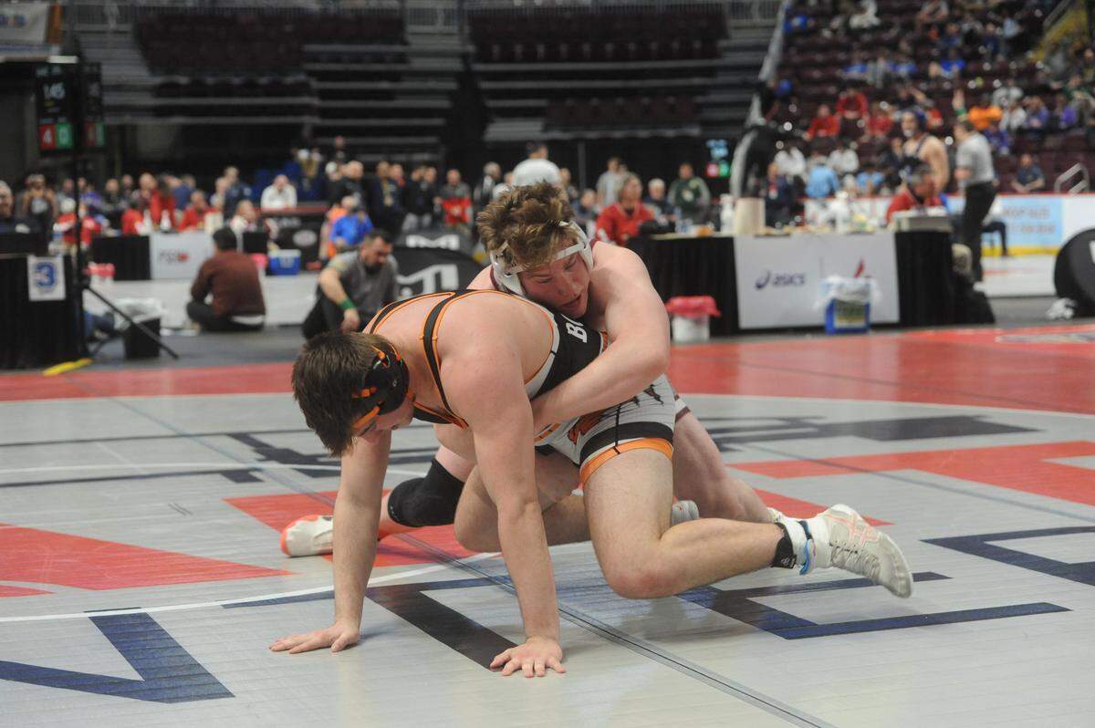 State College’s Nick Pavlechko finishes off a takedown of Latrobe’s Corey Boerio in their 215-pound second round match of the PIAA Class 3A Championships on Thursday, March 10, 2022 at Giant Center in Hershey. Pavlechko won 8-0 in his PIAA debut.