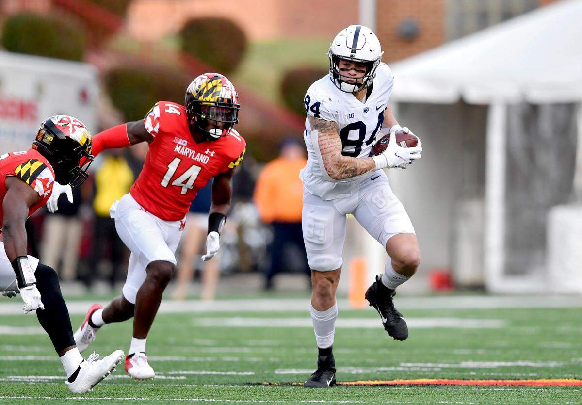 Penn State tight end Theo Johnson makes a catch and dodges Maryland defenders during the game on Saturday, Nov. 6, 2021.