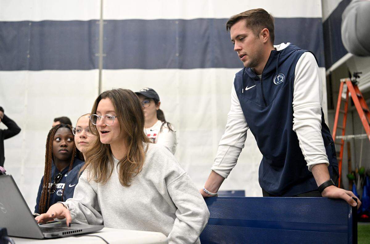 Penn State baseball’s director of operations and player development Jake Stone talks with student managers as they track pitching and hitting during practice on Thursday, Feb. 9, 2023 in Holuba Hall.