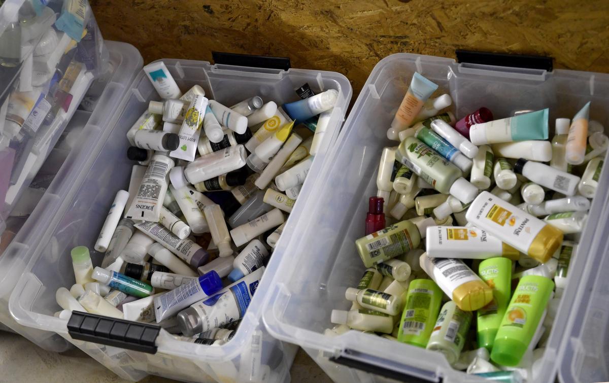 Tubs full of donated bottles of shampoo, condition and lotions for Little Bag of Sunshine.