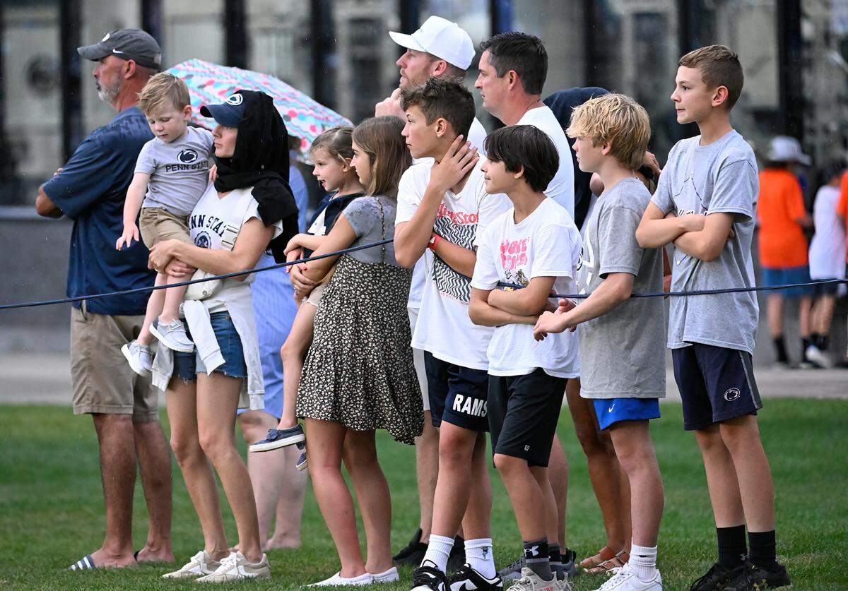 Fans sat through the rain to watch Penn State’s open football practice at the Lasch practice field Saturday, Aug. 12, 2023.