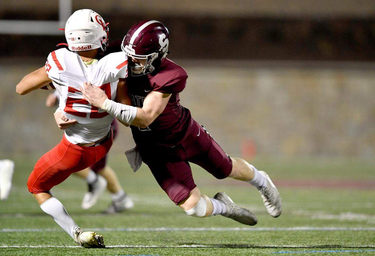 State College’s Sammy Knipe tackles Cumberland Valley's J.D. Hunter during the game on Friday, Oct. 9, 2020.  