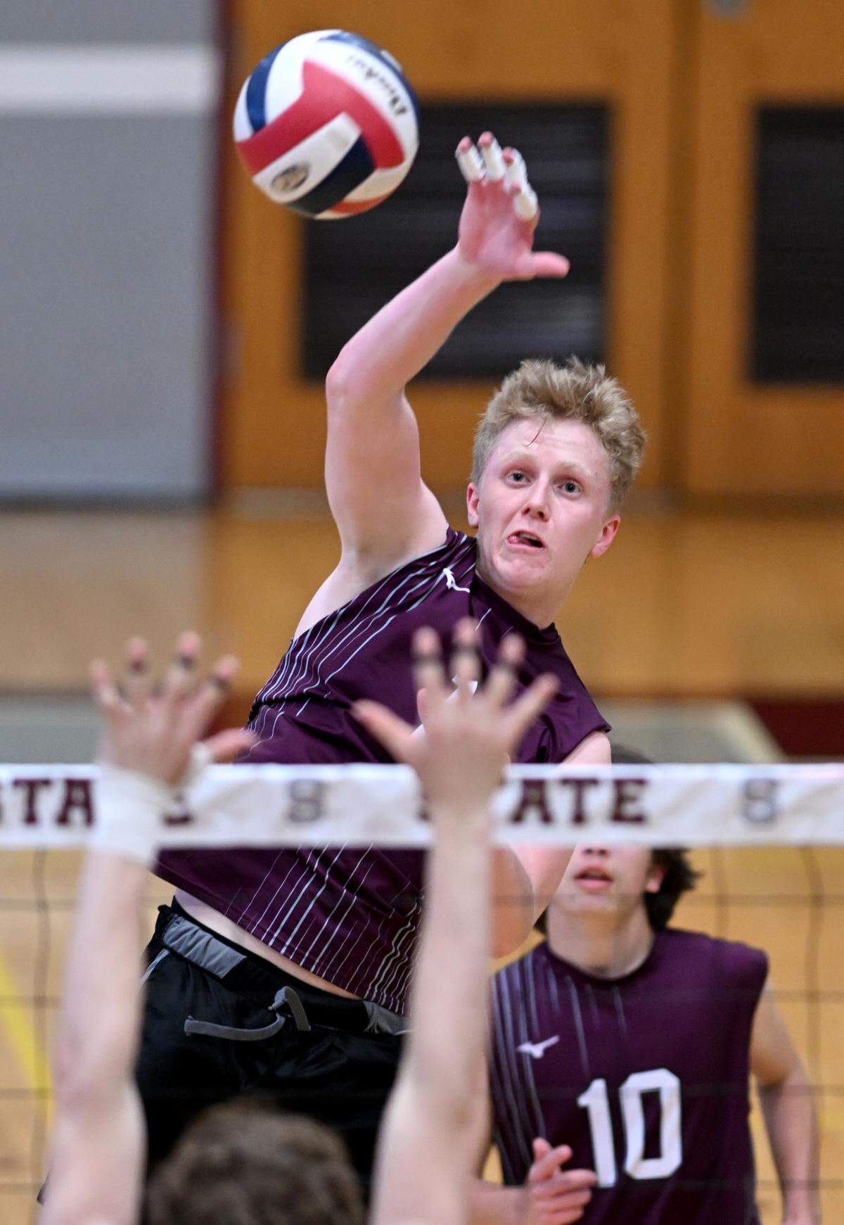State College’s Kieran Leahey hits the ball past a Central Dauphin defender during the boys volleyball game on Wednesday, May 10, 2023.