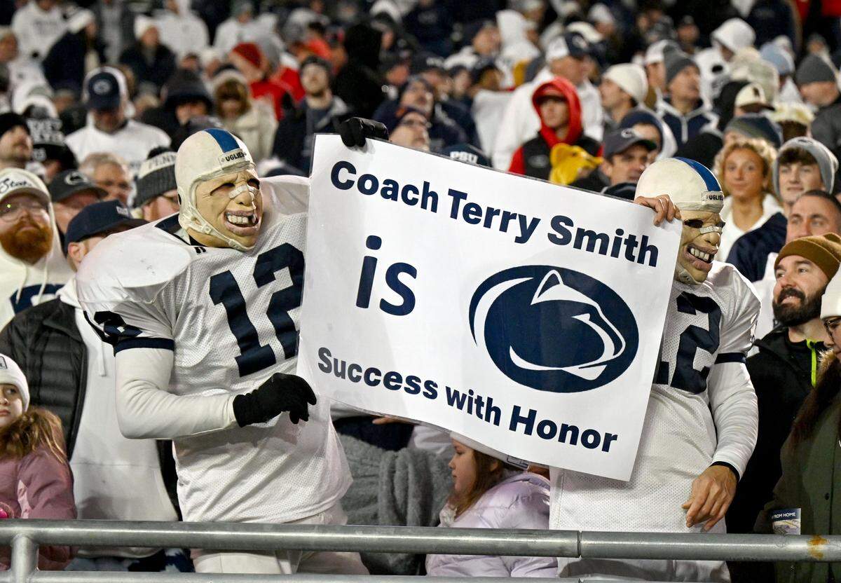 Penn State fans hold up a sign about interim coach Terry Smith during the game against Nebraska on Saturday, Nov. 22, 2025 at Beaver Stadium.