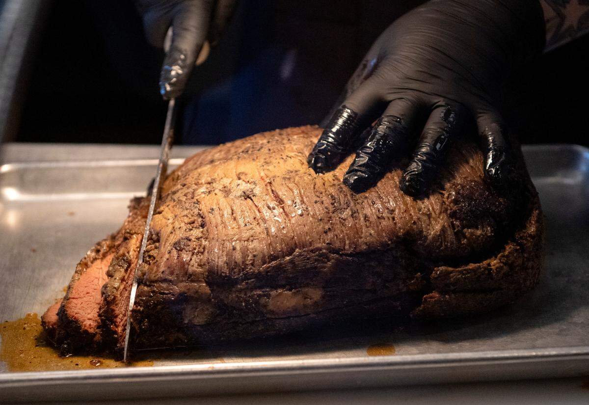 Brittany Witherite cuts beef brisket at Prospector’s on Thursday, June 1, 2023.