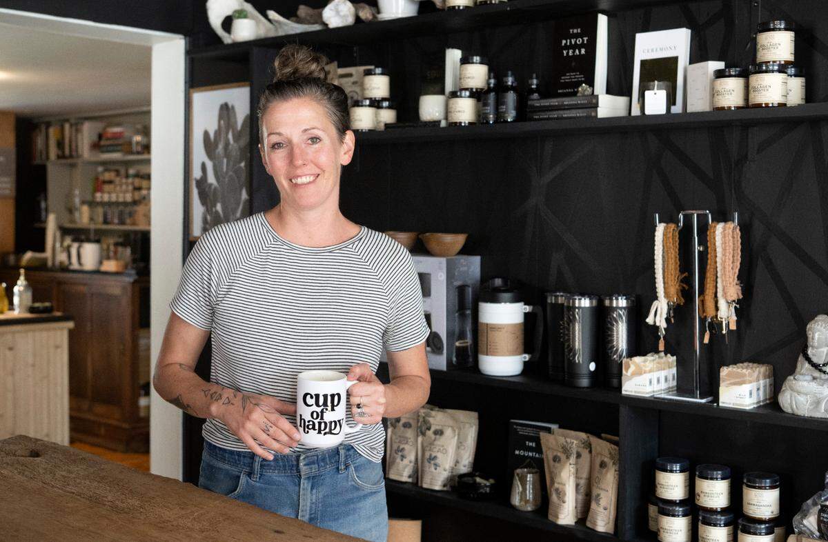 Rebecca Larson poses in Super Duper Cafe in Millheim. The cafe also sells local artisan products and shares the space with Rad Wheels Skate Shop.