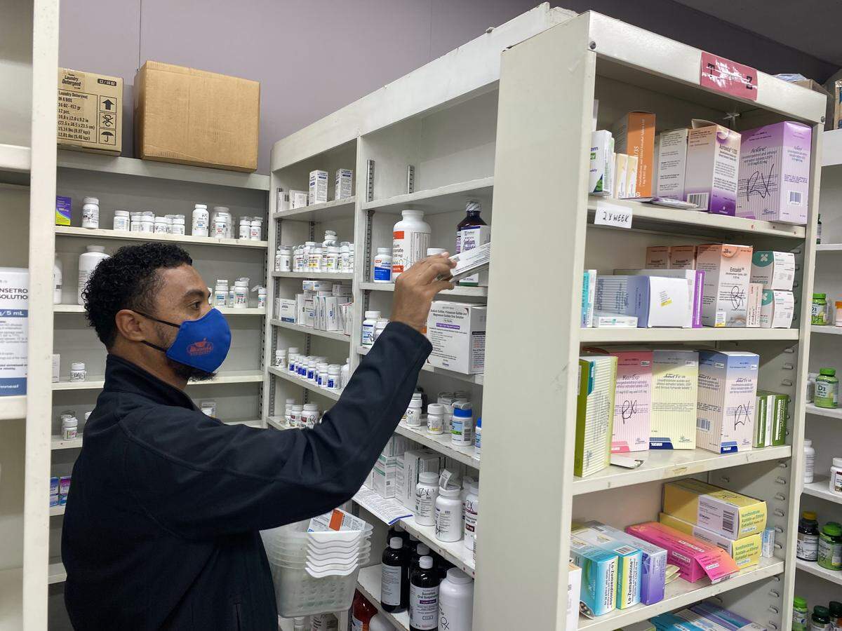 Kaye’l Marrero, a pharmacy technician and front-end supervisor at Minnich’s Pharmacy in York County, gathers medications.