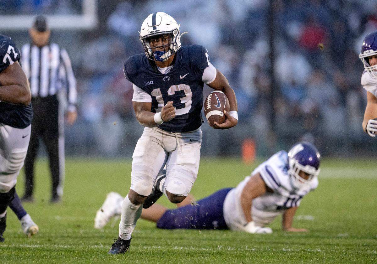 Penn State running back Kaytron Allen runs down the filed with the ball from Northwestern defenders during the game on Saturday, Oct. 1, 2022.