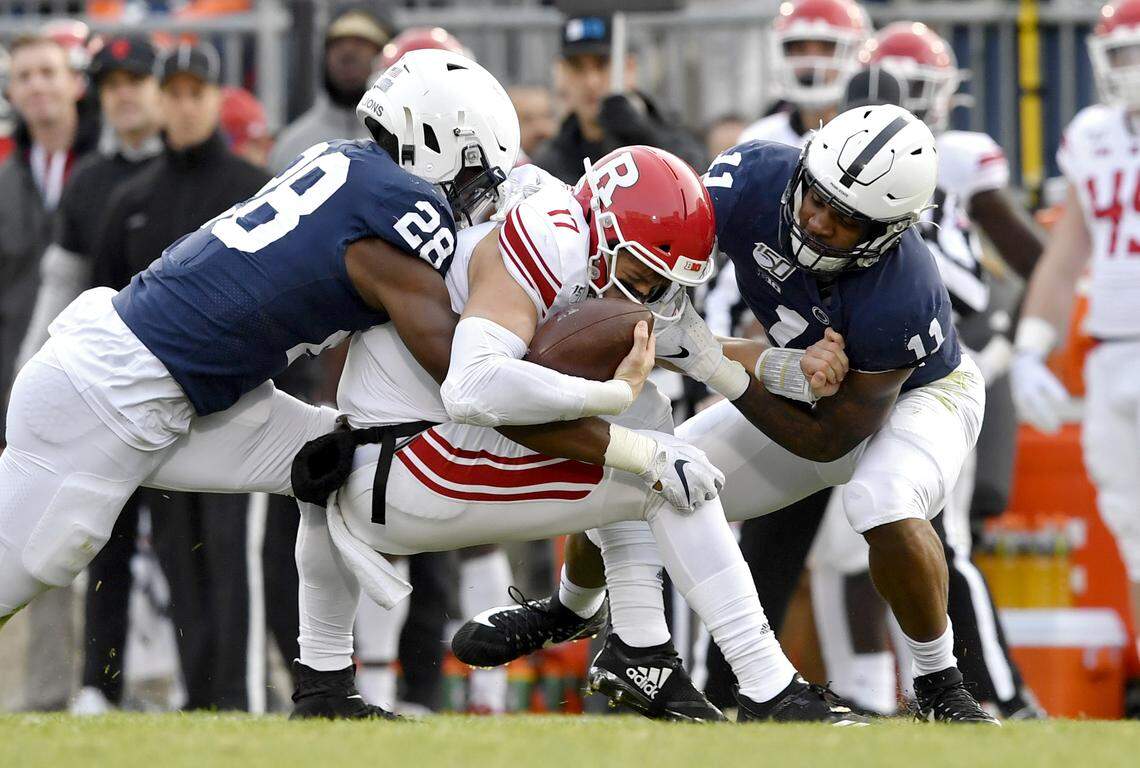 Penn State defensive end Jayson Oweh and linebacker Micah Parsons stop Rutgers quarterback Johnny Langan during the game on Saturday, Nov. 30, 2019, at Beaver Stadium.