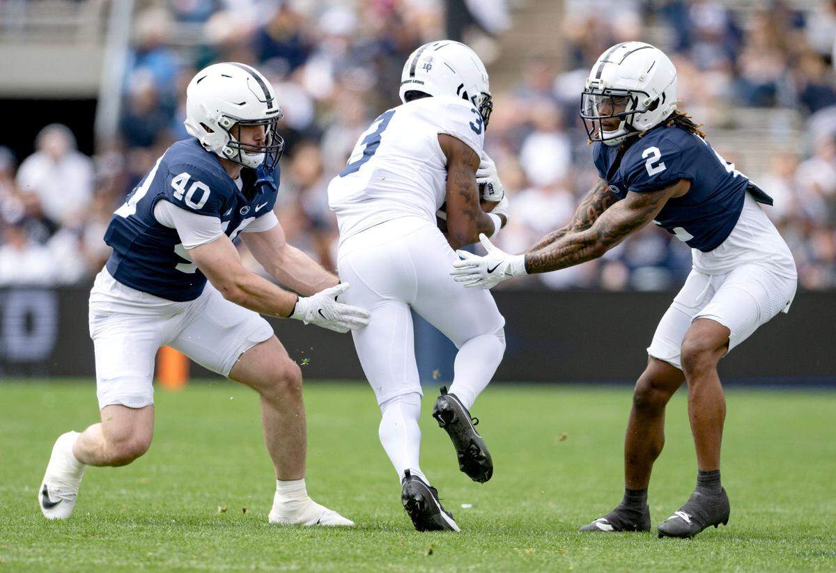 Penn State linebacker Anthony Speca and cornerback Audavion Collins stop wide receiver Koby Howard during the Blue-White game on Saturday, April 26, 2025.