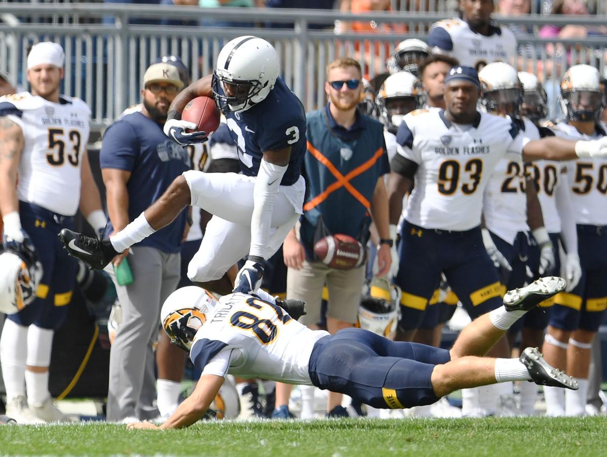 Penn State wide receiver DeAndre Thompkins jumps over Kent State kicker Matthew Trickett during a game Saturday, Sept. 15, 2018 at Beaver Stadium.