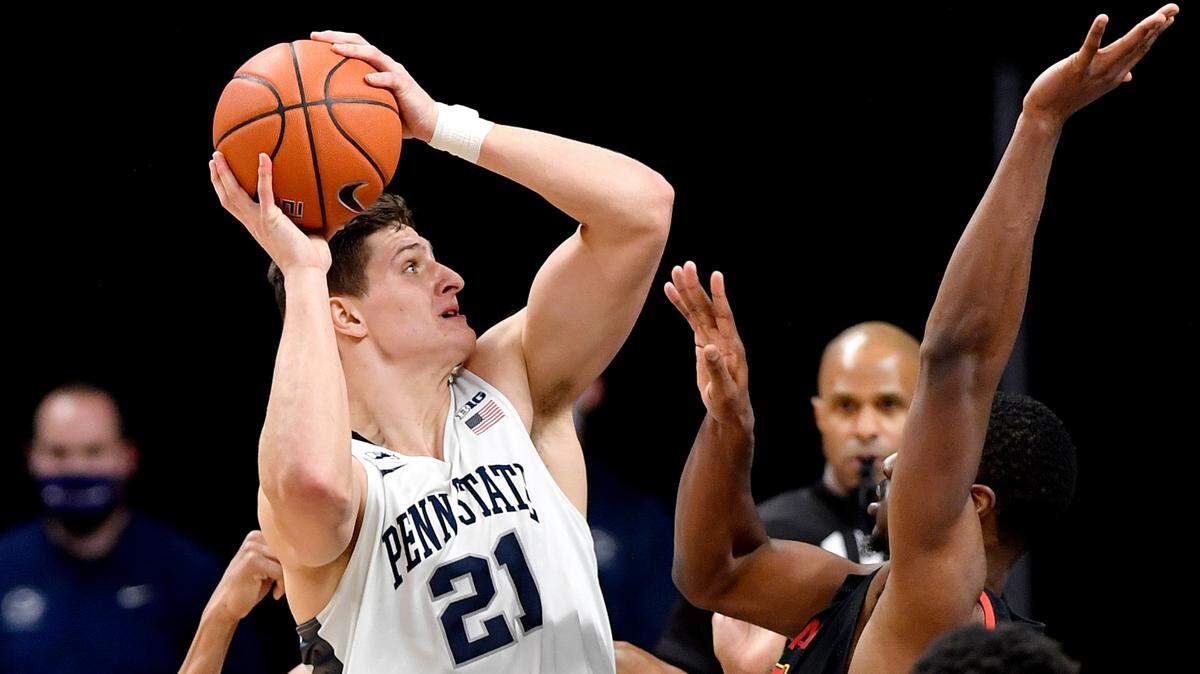 Penn State’s John Harrar looks to the basket around Maryland defenders during the game on Friday, Feb. 5, 2021 at the Bryce Jordan Center in State College, Pa.