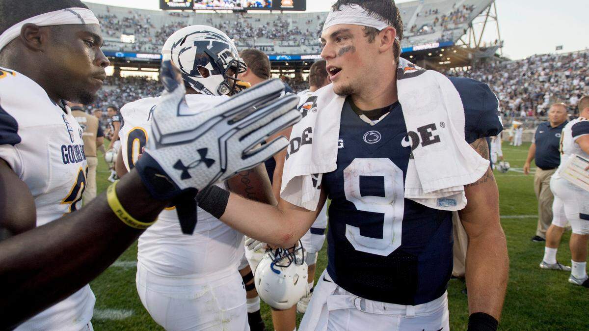 Penn State quarterback Trace McSorley high fives with Kent State players after the Saturday, September 3, 2016 game in Beaver Stadium. Kent State coach Sean Lewis said of McSorley, “A dynamic athlete; he can hurt you in a lot of different ways.”