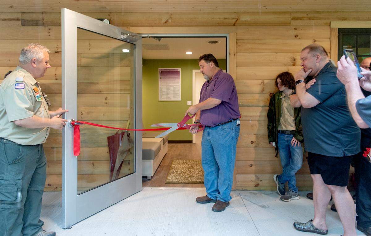 Don O’Connell cuts the ribbon for the David O’Connell Health Education Building at the Seven Mountains Scout Camp on Wednesday, June 22, 2022. The new facility will is to help the physical and mental health for the scouts.