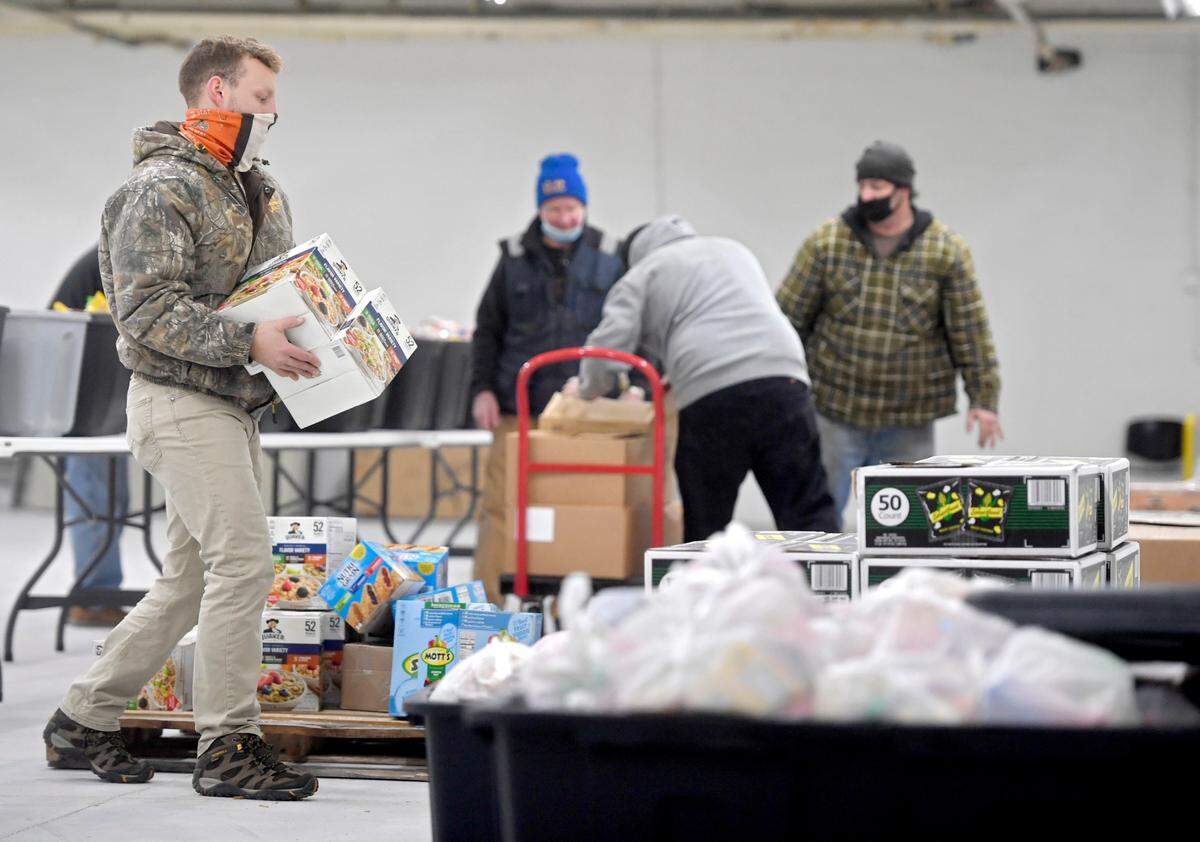 Chris Calliari helps to move and organize food items for the YMCA’s “No Child Hungry Distribution Center” at the Moshannon Valley Economic Development building on Jan. 8, 2021.