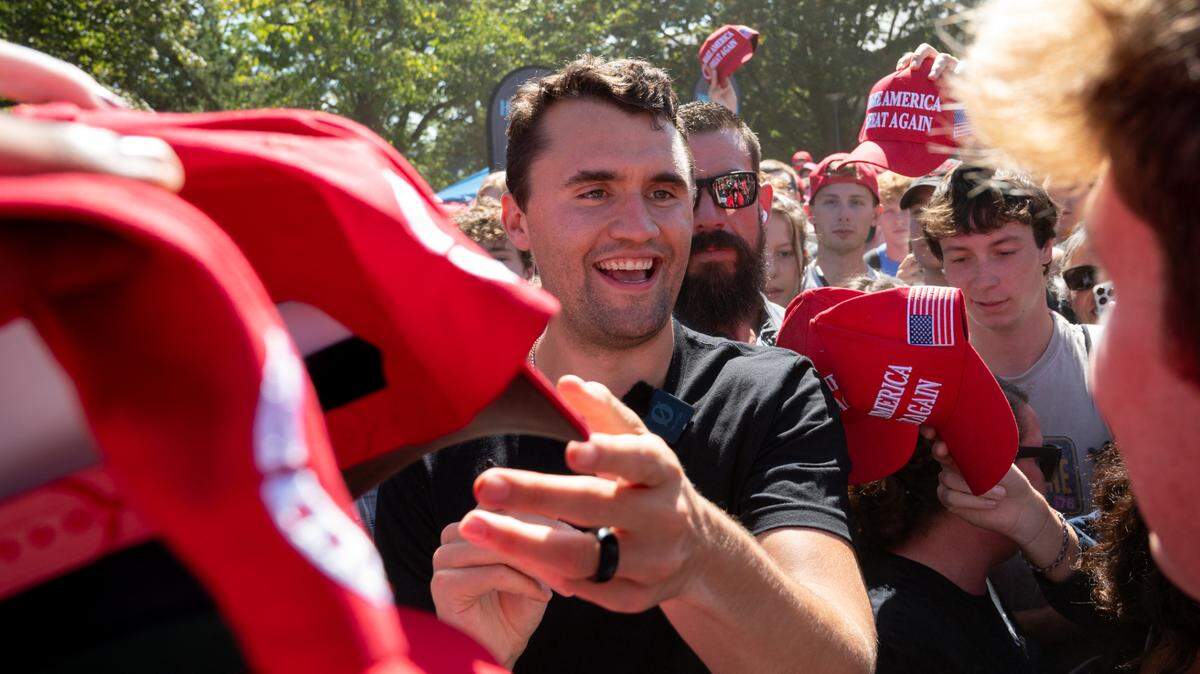 Charlie Kirk signs fan paraphernalia during the Turning Point “You’re Being Brainwashed Tour” on Thursday, Sept. 19, 2024.