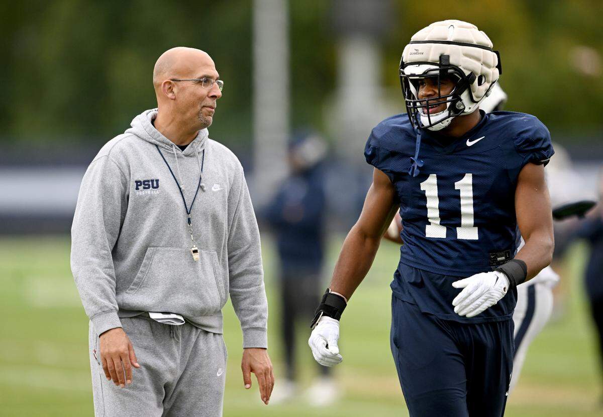 Penn State football coach James Franklin and linebacker Abdul Carter talk during practice on Wednesday, Oct. 18, 2023.