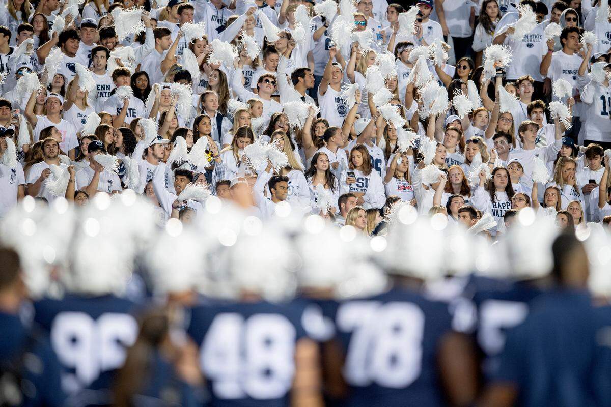 The Penn State student section cheers as the players huddle to warm up before the game against Indiana.