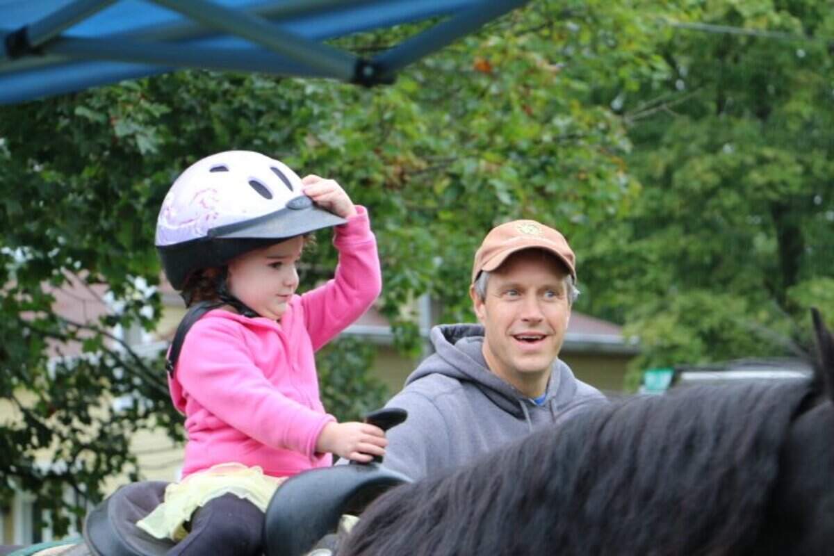 Alexis Stauffer, 3, rides Chessie, a pony, for the first time at the Dutch Fall Festival in Aaronsburg on Saturday.