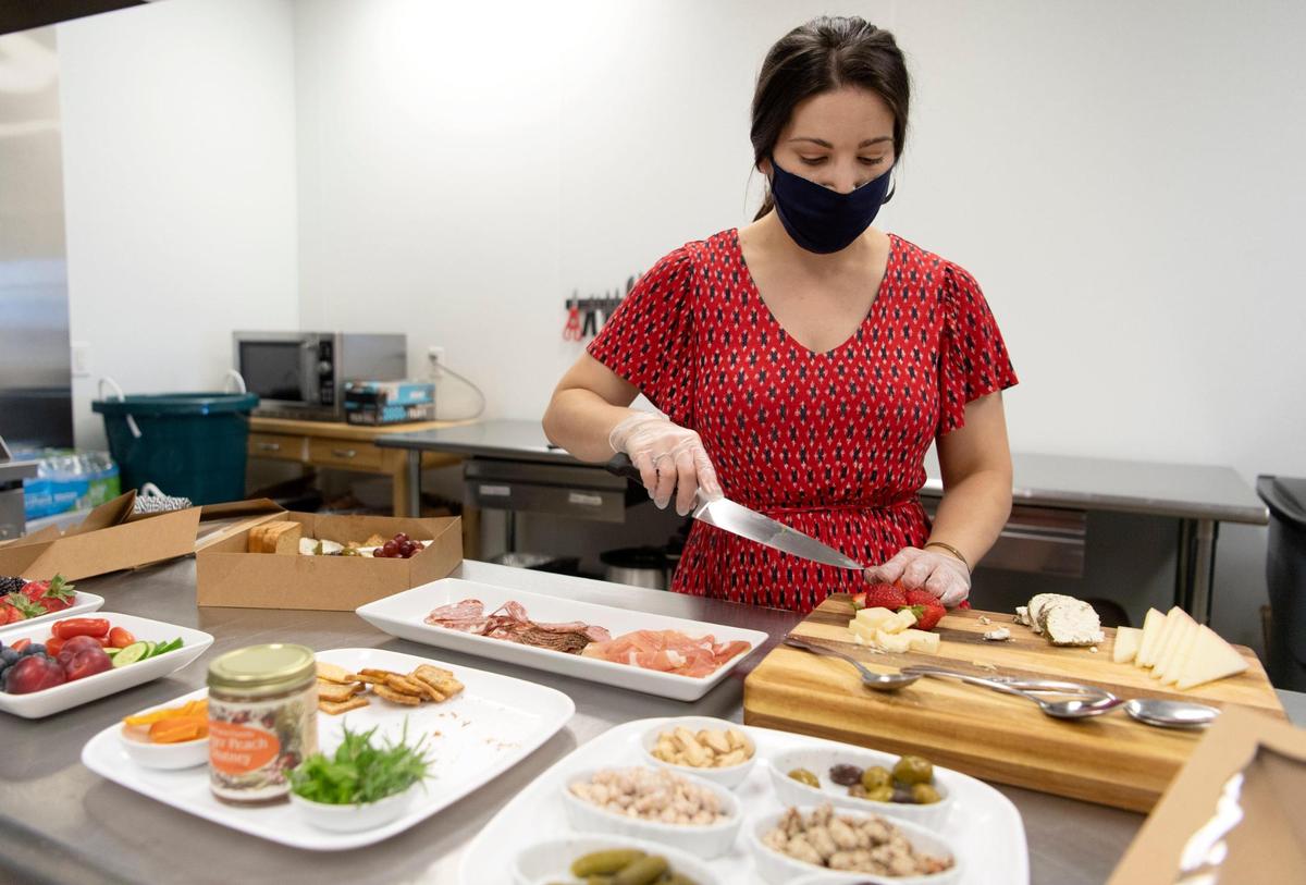 Amanda Cruz of The Gourmet Girl Personal Chef Service prepares some strawberries for a grazing box on Monday, August 3, 2020. Each box is different and features meats, cheeses, fruits and more.