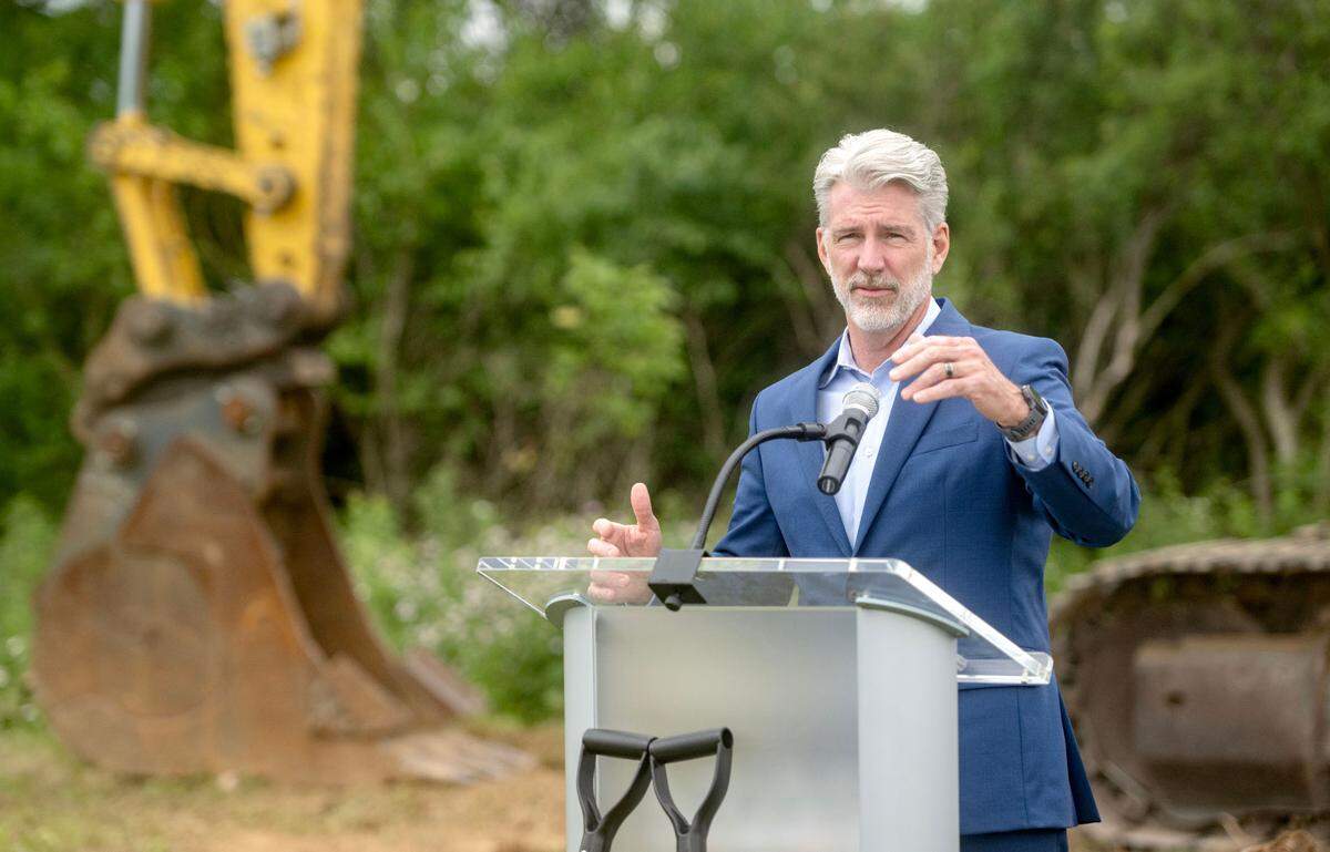 Gerg Scott, President and CEO of Chamber of Business and Industry of Centre County, speaks about the growth along Benner Pike during the groundbreaking ceremony for the Tru Hotel by Hilton that will start being built.
