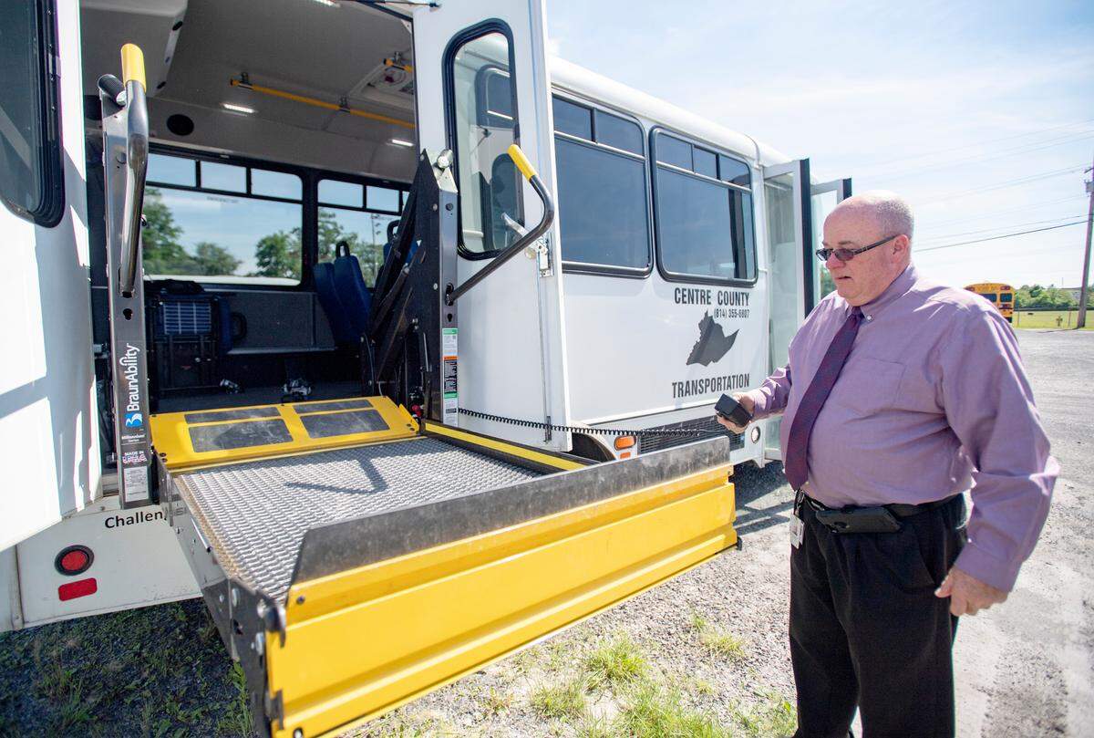 David Lomison, the Centre County Office of Transportation’ director, shows how the lift works on one of the county’s mini-buses.