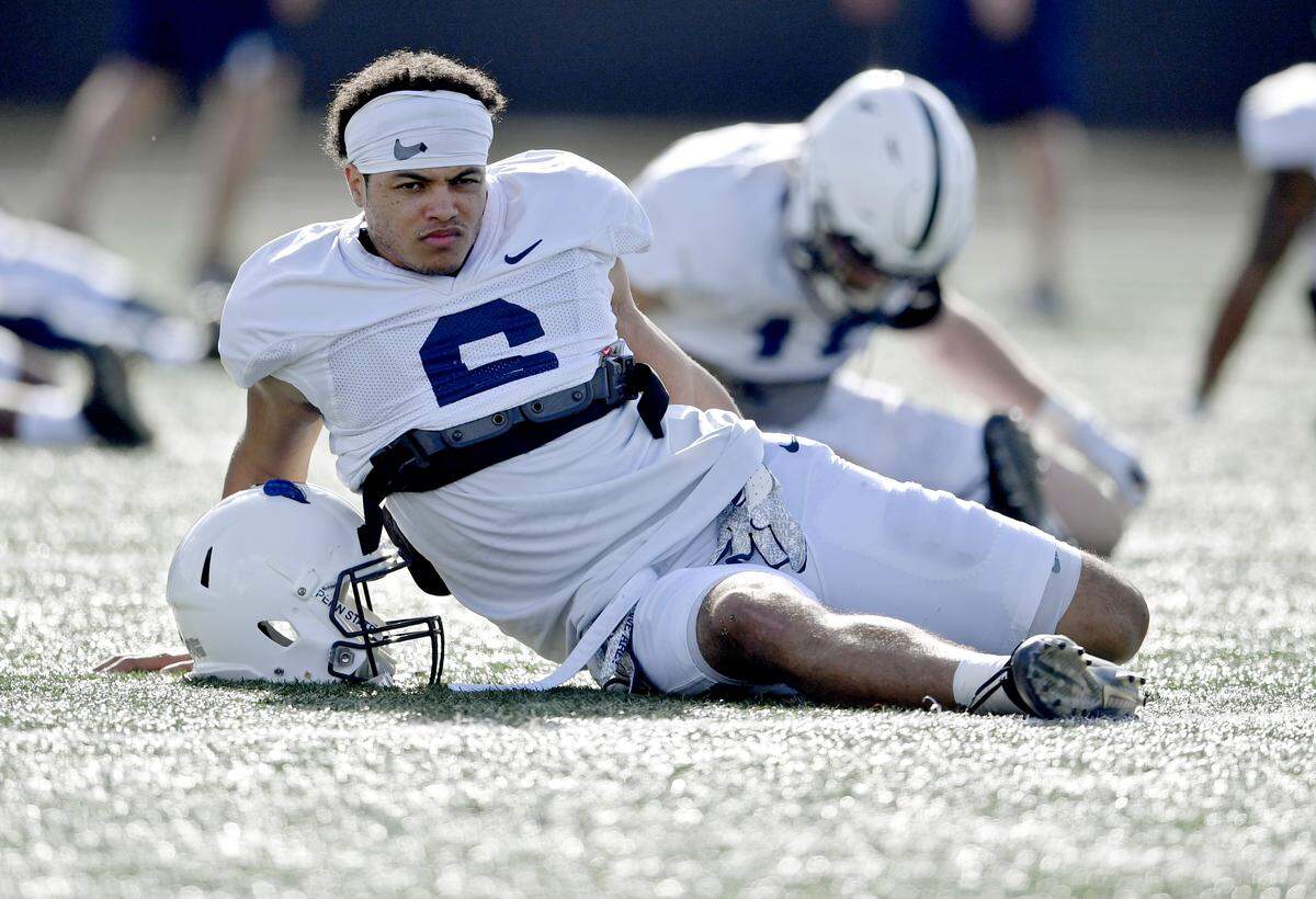 Penn State cornerback John Reid stretches for practice on Sunday, Dec. 30, 2018 at Celebration High School.  For the last practice of the season players traded jerseys with a teammate. 