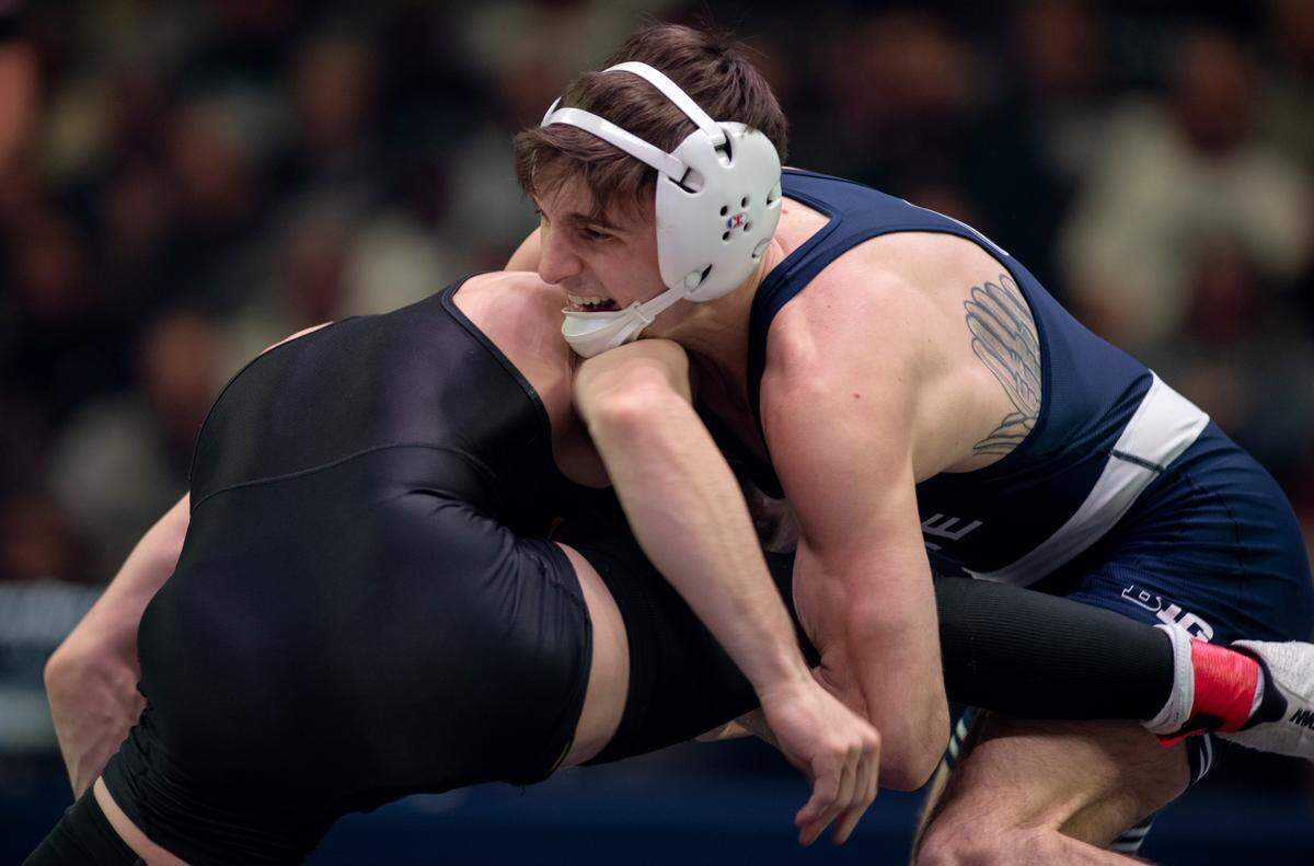 Penn State’s Marco Vespa gets a quick shot at Iowa’s Spencer Lee to start their 125 lb bout during the match on Friday, Jan. 27, 2023 at the Bryce Jordan Center.