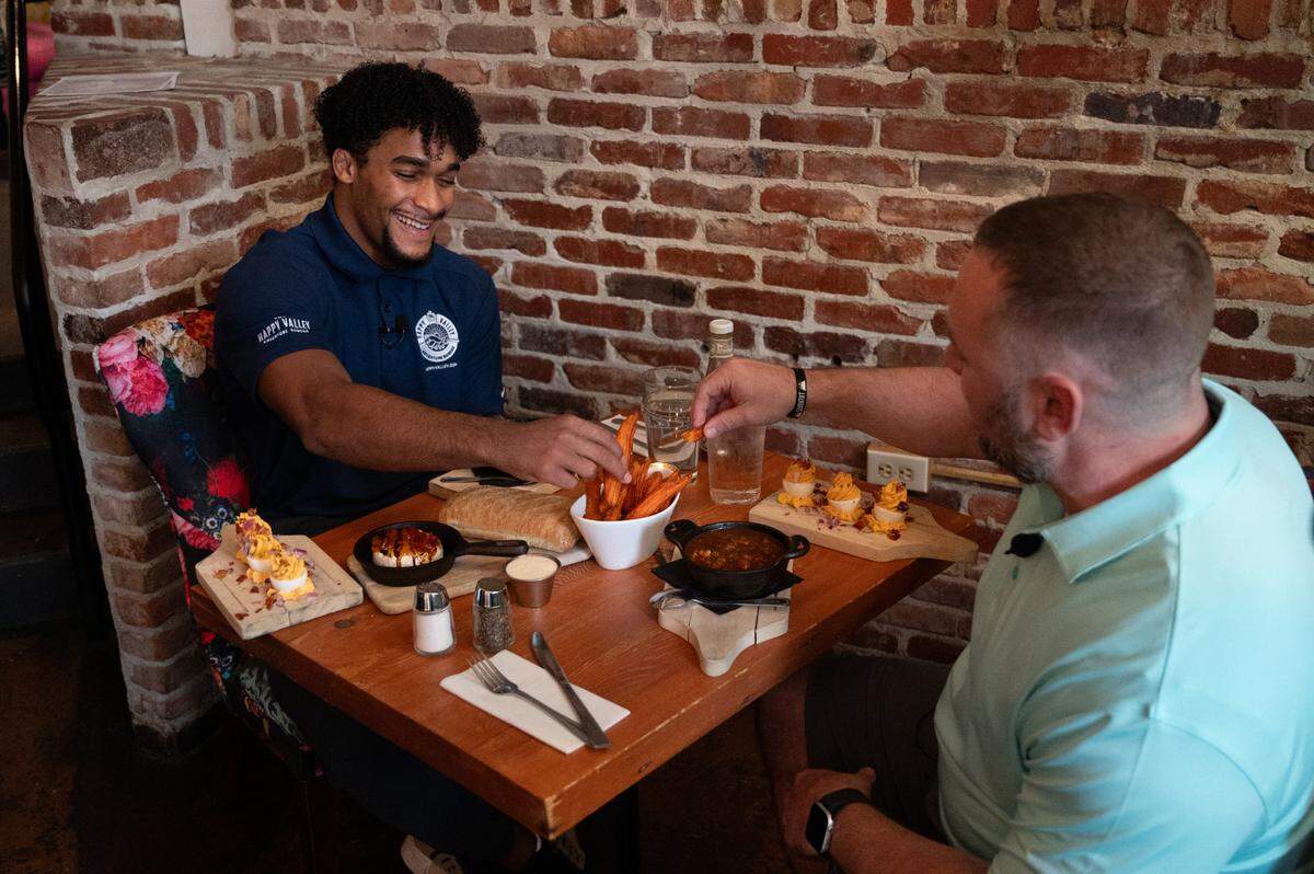 Carter Starocci eats french fries for “Carter’s Drive and dine for Five” at Gigi’s Southern Table on Wednesday, Sept. 18, 2024.
