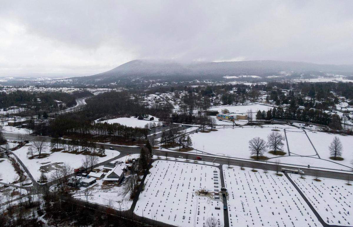 Clouds partially cover Mount Nittany during a snowy morning on Monday, Jan. 23, 2023.