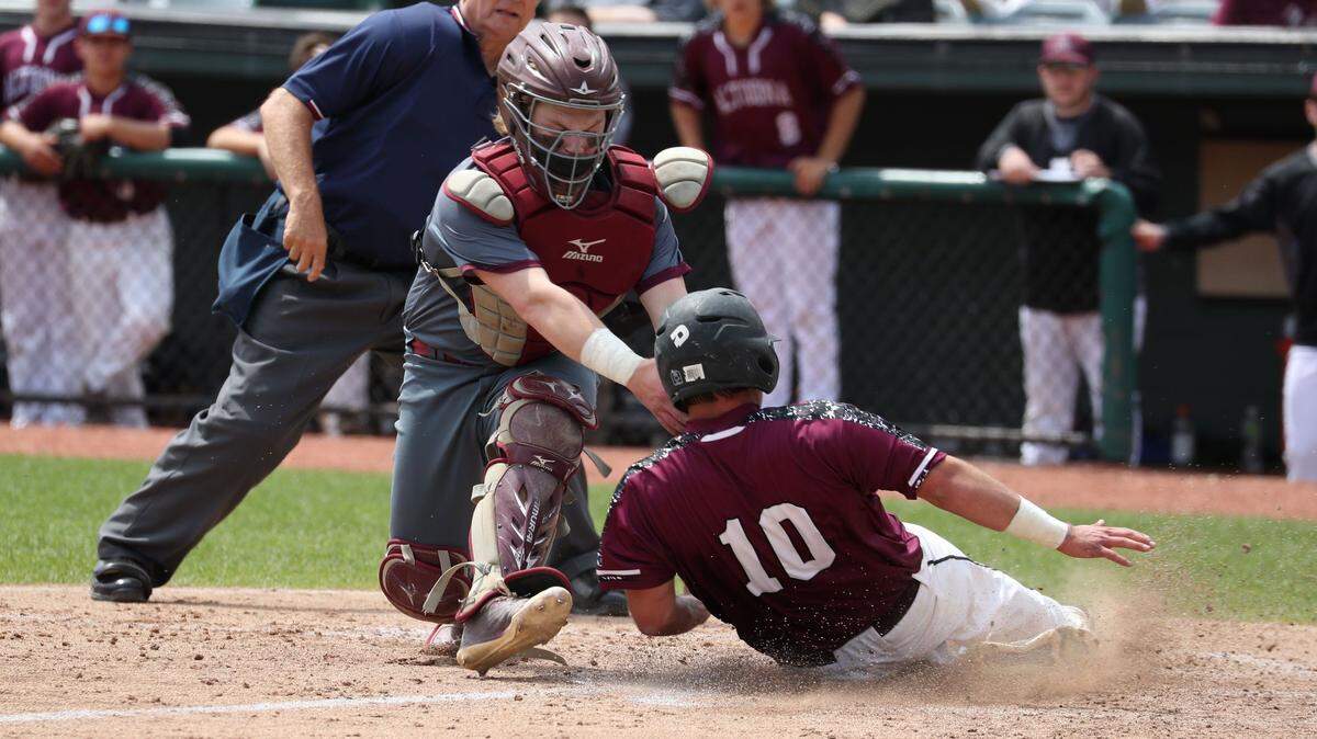 State College catcher Tyson Cooper tags out Altoona’s Adam Sinisi on a crucial play in the fifth inning Wednesday during the Little Lions’ 7-3 win over Altoona in the District 6 Class 6A Championship at Peoples Natural Gas Field. Right fielder Jake Hillard made the throw.