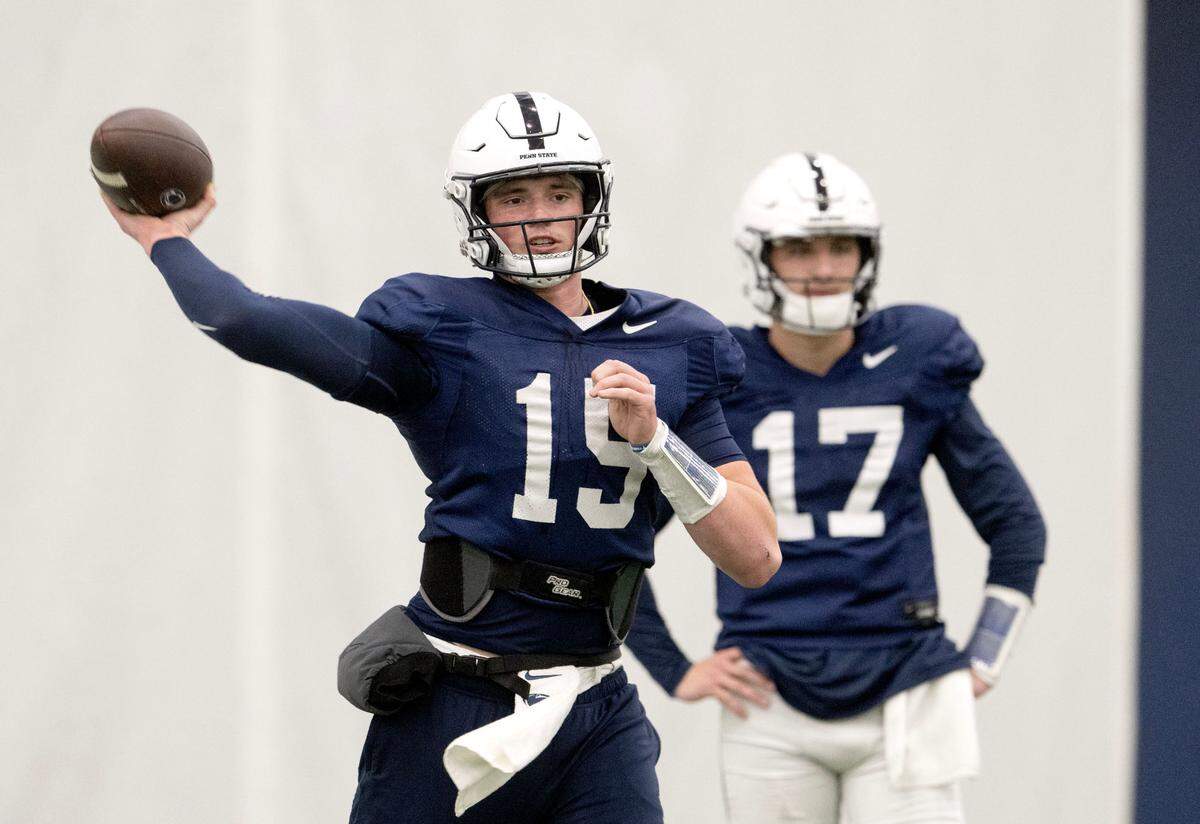 Penn State quarterback Drew Allar makes a pass as Ethan Grunkemeyer watches during practice on Wednesday, Dec. 18, 2024.